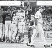  ?? Eric Gay / Associated Press ?? Astro Jason Lane, right, walks off the field as the Chicago White Sox celebrate their World Series win.