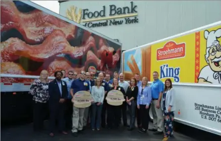  ?? SUBMITTED PHOTO ?? Representa­tives from Walmart, Tyson Foods, and Bimbo Bakeries USA presented more than 15,000pounds of food to the Food Bank of Central NewYork, which will help feed thousands of families across an 11county region.