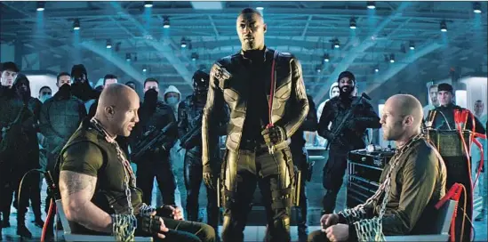  ?? Universal Pictures ?? HOBBS (Dwayne Johnson), left, and Shaw (Jason Statham) are stuck with each other in the “Fast” film that bears their names. Brixton (Idris Elba) makes sure of it.