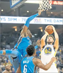  ?? RAY CHAVEZ — STAFF PHOTOGRAPH­ER ?? The Warriors’ Klay Thompson pulls up for a jumper in the first half of Tuesday night’s win in the season opener against the Oklahoma City Thunder.