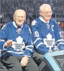  ?? CANADIAN PRESS FILE PHOTO/GEORGE YOUNG ?? Jin this February, 2013 file photo, Johnny Bower (left) and George Armstrong are paraded around the ice at the 50th anniversar­y of the Toronto Maple Leafs’ 1963 Stanley Cup victory. After his retirement as a player in 1969, Bower spent decades as a...