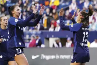  ?? AP ?? SAN DIEGO Wave’s Alex Morgan (13) is greeted by midfielder Taylor Kornieck during their match against the OL Reign during the first half of National Women’s Soccer League match in April in Seattle.