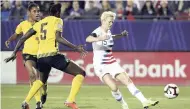  ?? AP ?? United States forward Megan Rapinoe scores a powerful effort while being tracked by Jamaica defender Konya Plummer (centre) as her teammate Dominique Bond-Flasza looks on during the first half of a CONCACAF women’s World Cup qualifying match in Frisco, Texas, last night.