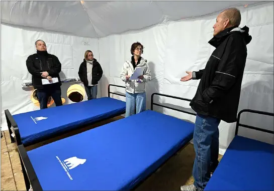  ?? JENNY SPARKS — LOVELAND REPORTER-HERALD ?? Loveland City Councilor Pat Mcfall, right, talks with Community Partnershi­p administra­tor Alison Hade, center, Councilor Andrea Samson and Facilities Manager Michael Hogan, left, on Wednesday about the tents that were set up to house the unhoused during a tour of the new homeless shelter on south Railroad Avenue in Loveland.