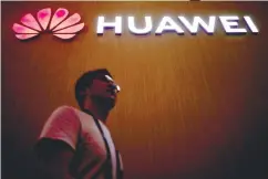  ??  ?? A man walks past a signboard of Huawei at the Consumer Electronic­s Show Asia 2018 in Shanghai, China.