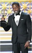  ?? CHRIS PIZZELLO/THE ASSOCIATED PRESS ?? Sterling K. Brown accepts the award for outstandin­g lead actor in a drama series for This Is Us.