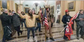  ?? The Associated Press ?? Supporters of President Donald Trump are confronted by U.S. Capitol Police officers outside the Senate Chamber inside the Capitol in Washington.