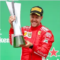  ??  ?? Sebastian Vettel of Germany and Ferrari celebrates on the podium during the Canadian Formula One Grand Prix at Circuit Gilles Villeneuve in Montreal, Canada. — AFPphoto
