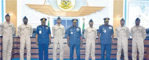  ?? NAF PHOTO: NAN ?? Chief of Air Staff, Air Marshal Isiaka Oladayo- Amao ( middle); Chief of Policy and Plans, Nigeria Air Force ( NAF), Air Vice Marshal Remigius Ekeh ( 3rd left); Chief of Training and Operations, NAF, Air Vice Marshal James Gwani ( 3rd right) and newly graduated Pilots, during the Winging of Pilots in Abuja… yesterday