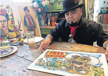  ?? [ASSOCIATED PRESS FILE PHOTO] ?? In this April 5 photo, artist Moises Salcedo of Albuquerqu­e shows an early rendition of the lead character for the bilingual children’s book “Owl in a Straw Hat” at his home and studio in Albuquerqu­e, N.M.