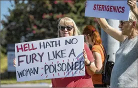  ?? PHOTOS BY ALYSSA POINTER / ALYSSA.POINTER@AJC.COM ?? Jenni Shover of Smyrna protests Thursday about a half-mile from the Cobb County Sterigenic­s plant.