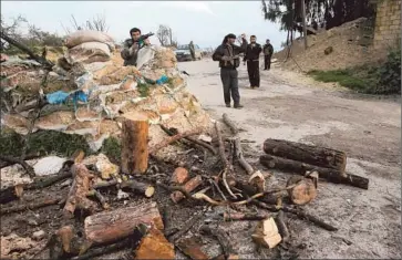  ?? Hussein Malla
Associated Press ?? MEMBERS OF the rebel Free Syrian Army guard a checkpoint in Idlib province. As class resentment­s surface, some rebels complain that better-educated civilians feel entitled to positions of power.