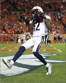  ??  ?? Los Angeles Chargers wide receiver Travis Benjamin (12) pulls in a touchdown catch against the Denver Broncos during the second half of an NFL football game, Monday in Denver. AP PHOTO/DAVID ZALUBOWSKI