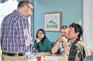  ??  ?? Dwayne Surette, area chief resource management for DFO, talks with Pubnico fishermen Claude d’Entremont, Michael Little and Angie Little during a break at the Fishing for Opportunit­ies open informatio­n session at the Acadian Village in Lower West Pubnico on March 12.