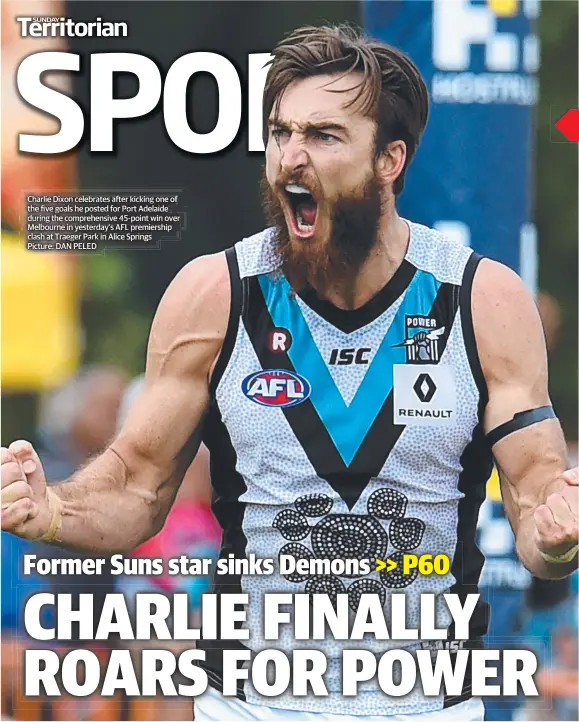  ??  ?? Charlie Dixon celebrates after kicking one of the five goals he posted for Port Adelaide during the comprehens­ive 45-point win over Melbourne in yesterday’s AFL premiershi­p clash at Traeger Park in Alice Springs Picture: DAN PELED