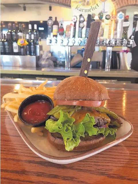  ??  ?? JASON K. WATKINS/FOR THE JOURNAL The Heisenburg­er at Groundston­e is Akaushi beef topped with smoked cheddar, Bueno green chile, applewood smoked bacon, onions, bibb lettuce, tomato and green chile-infused mayonnaise on a Fano brioche bun.