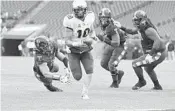  ?? COREY PERRINE/GETTY IMAGES ?? UCF’s McKenzie Milton walks in for the first TD of the game against Temple on Saturday in Philadelph­ia, Pa.