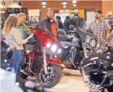  ?? STEVE HELBER/ASSOCIATED PRESS ?? Customers look over Harley-Davidson motorcycle­s on display at a dealership in Ashland, Virginia. On Thursday, the Commerce Department issues its September report on consumer spending.