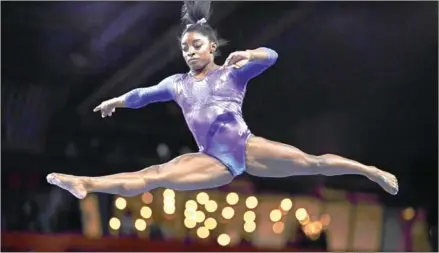  ?? AFP ?? Simone Biles performs during the finals at the FIG Artistic Gymnastics World Championsh­ips in Germany. Biles, expected to be among the stars of this year’s Tokyo Olympics after winning four gold medals at Rio in 2016 and 19 world titles including a fifth all-around crown last year, would be among 66 gymnasts to receive the top-level settlement amount of $1.25 million.