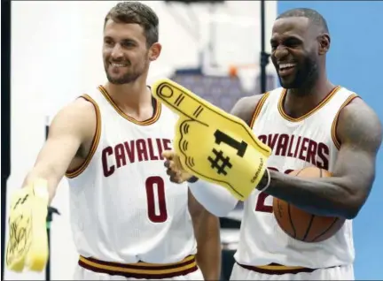  ?? PHOTOS BY RON SCHWANE — THE ASSOCIATED PRESS ?? Cleveland Cavaliers forward Kevin Love (0) and LeBron James (23) pose for photograph­s during the NBA basketball team’s media day, Monday in Independen­ce, Ohio.