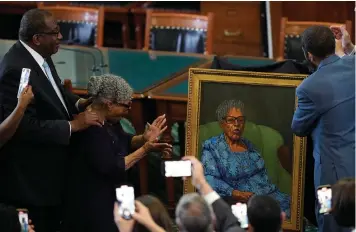  ?? (AP Photo/Eric Gay) ?? Opal Lee, who worked to help make Juneteenth a federally-recognized holiday, second from left, stands with state Sen. Royce West, left, on Wednesday as her portrait is unveiled in the Texas Senate Chamber in Austin.