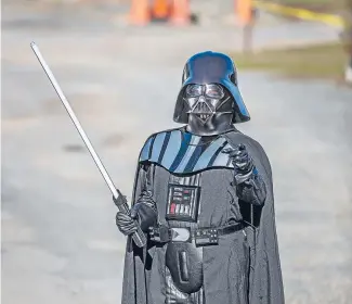  ?? Photo: JOHN KIRK-ANDERSON/FAIRFAX NZ ?? enthusiast David Britten entertains children as Darth Vader, to give them an opportunit­y he never had.