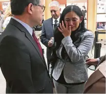  ?? Kathleen Ronayne / Associated Press ?? California Treasurer John Chiang speaks to Erica Porteus, whose sister was killed in the 2015 San Bernardino attack.