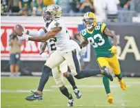  ?? STEPHEN B. MORTON/ASSOCIATED PRESS ?? Saints free safety Marcus Williams, left, intercepts a pass in front of Packers wide receiver Marquez Valdes-Scantling during the second half of Sunday’s game in Jacksonvil­le, Fla.