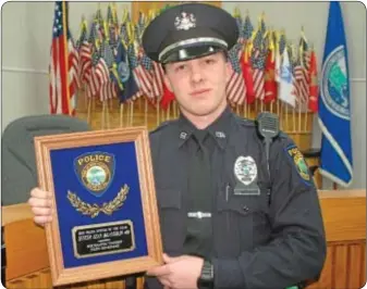  ??  ?? Officer Sean McLaughlin with the 2012 Officer of the Year Award presented by the Northampto­n Township Police Department.