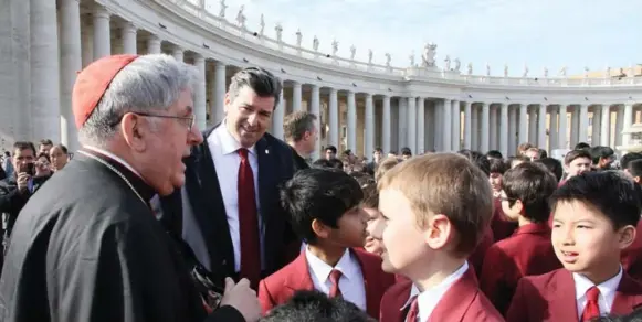  ?? GEORGE HOSEK PHOTO ?? Cardinal Thomas Collins greets students from St. Michael’s Choir School and director Stephen Handrigan in St. Peter’s Square in Rome, where they sang for Pope Francis.