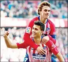  ??  ?? Atletico Madrid’s Spanish midfielder Rodrigo celebrates with teammate, French forward Antoine Griezmann after scoring a goal during the Spanish League football match between Club Atletico de Madrid and Deportivo Alaves at the Wanda Metropolit­ano stadium in Madrid on Dec 8. (AFP)