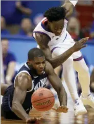  ?? ORLIN WAGNER — THE ASSOCIATED PRESS ?? Villanova forward Eric Paschall, left, and Kansas guard Marcus Garrett race for a loose ball during the first half of Saturday’s game in Lawrence, Kan.