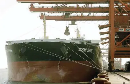  ??  ?? A bulk carrier cargo ship docks at an iron ore transfer and storage centre in Shanghai. China has proposed a cut on tax for iron ore mined in the country. – Bloomberg