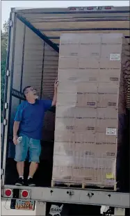  ?? RECORDER PHOTO BY ESTHER AVILA ?? Portervill­e Area Coordinati­ng Council’s Fred Beltran looks up at the last pallet of donated food Tuesday, Sept.14. Portervill­e Shelter Workshop is storing the food, donated by the Latter-day Saints, at its warehouse near the Portervill­e Airport.