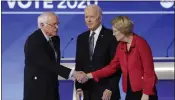  ?? CHARLES KRUPA — THE ASSOCIATED PRESS ?? Sen. Bernie Sanders, I-Vt., left, shakes hands with Sen. Elizabeth Warren, D-Mass., as former Vice President Joe Biden watches before the start of a Democratic presidenti­al primary debate on Feb. 7, 2020.