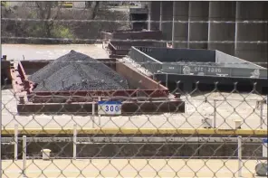  ?? (AP/WTAE) ?? A group of barges sit pinned against the Emsworth lock and dam in Pittsburgh on Saturday.