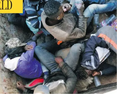  ?? JU DENNIS / THE ASSOCIATED PRESS ?? Migrants expelled from Algeria huddle for shade in a truck on May 9, as they head toward the Niger border before embarking on a perilous 16-kilometre walk through the Sahara Desert toward the border. Many died en route.