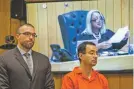  ?? CORY MORSE /THE GRAND RAPIDS PRESS VIA AP ?? Larry Nassar, right, listens near defense attorney Matthew Newberg as Judge Janice Cunningham (pictured on the monitor) sentences Nassar on Monday in Eaton County Circuit Court in Charlotte, Mich.