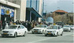  ?? (Marc Israel Sellem/The Jerusalem Post ?? TAXIS FIND more than the usual number of people looking for a ride at Jerusalem’s Central Bus Station yesterday.