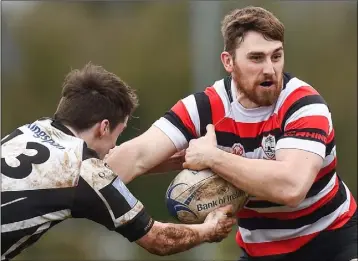  ??  ?? David O’Dwyer of Enniscorth­y is tackled by Dundalk’s Daragh Conroy.