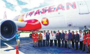  ??  ?? ... AirAsia Group chief executive officer Tan Sri Tony Fernandes (seventh from left) with officials and staff from AirAsia Malaysia, Indonesia, Thailand and the Philippine­s posing with an aircraft featuring the ‘I Love Asean’ livery in Manila yesterday.