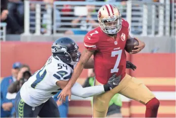  ?? KYLE TERADA, USA TODAY SPORTS ?? Colin Kaepernick runs past Seahawks linebacker Bobby Wagner on Jan. 1 in what proved to be the quarterbac­k’s last game with the 49ers. Kaepernick was drafted by the Niners in 2011.