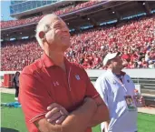  ?? MARK HOFFMAN / MILWAUKEE JOURNAL SENTINEL ?? Ted Kellner (left) watches the scoreboard as the University of Wisconsin announces his gift of $25 million to the school during the Badgers’ game against Maryland at Camp Randall Stadium in Madison on Saturday.