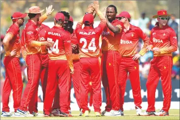  ??  ?? Zimbabwe cricketer Tendai Chatara (third right) celebrates with his teammates after he dismissed Sri Lankan cricketer Niroshan Dickwella during the first one-day internatio­nal (ODI) cricket match between Sri Lanka and Zimbabwe at the Galle...