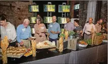  ??  ?? A documentar­y played on a video board as guests enjoyed the prepared foods from local farms during the Food Well Alliance’s annual Love Local event at the King Plow Arts Center on Oct. 5.