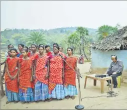  ?? GAYATRI JAYARAMAN/HT PHOTO ?? ▪ All India Radio executives record (left) a flute recital and (top) folk song at a Santhali village. Equipped with rudimentar­y devices and a desire to preserve heritage, they trek to villages where roads haven’t been laid yet.