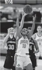  ?? ADAM CAIRNS/COLUMBUS DISPATCH ?? Ohio State Buckeyes guard Braxtin Miller (10) grabs a rebound away from Michigan guard Elise Stuck (30) during the second quarter at Value City Arena Thursday.