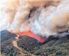  ?? MIKE ELIASON/SANTA BARBARA COUNTY FIRE DEPARTMENT ?? Flames advance toward a large firebreak near homes along Gibraltar Road north of Santa Barbara, Calif., on Saturday.