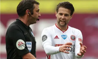  ??  ?? Sheffield United’s Oliver Norwood confronts Michael Oliver at Villa Park but referee could not award the goal. Photograph: Carl Recine/ PA/NMC Pool