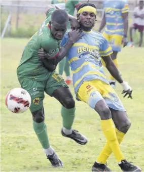  ?? (Photo: Karl Mclarty) ?? Humble Lions’ Lorenzo Lewin (left) and Denardo Thomas of Waterhouse duel for possession during their Jamaica Premier League preliminar­y round encounter at Waterhouse Stadium in Drewsland, St Andrew, on Sunday, May 7.